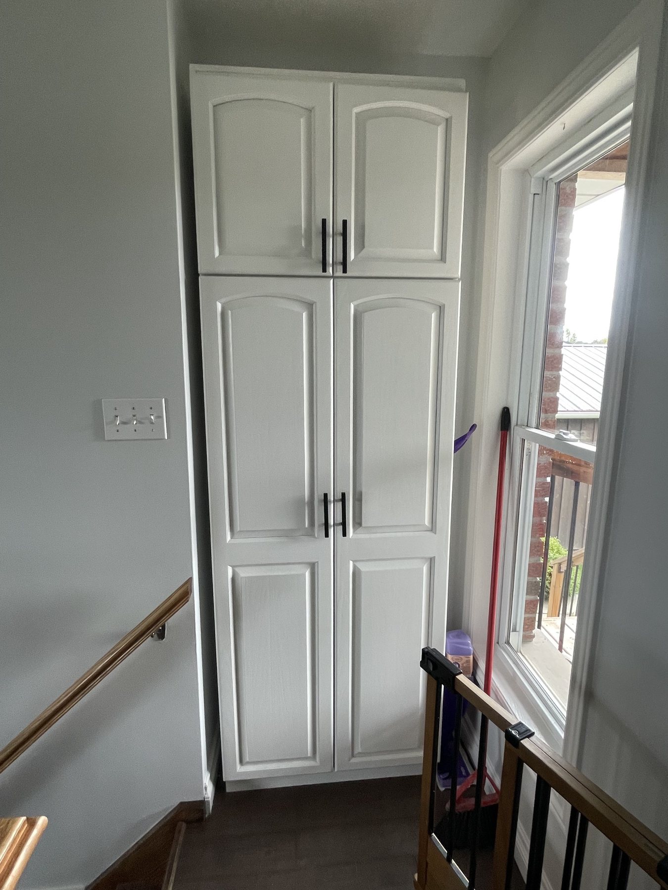 Tall cabinet refinishing and storage cabinet painting near stairway