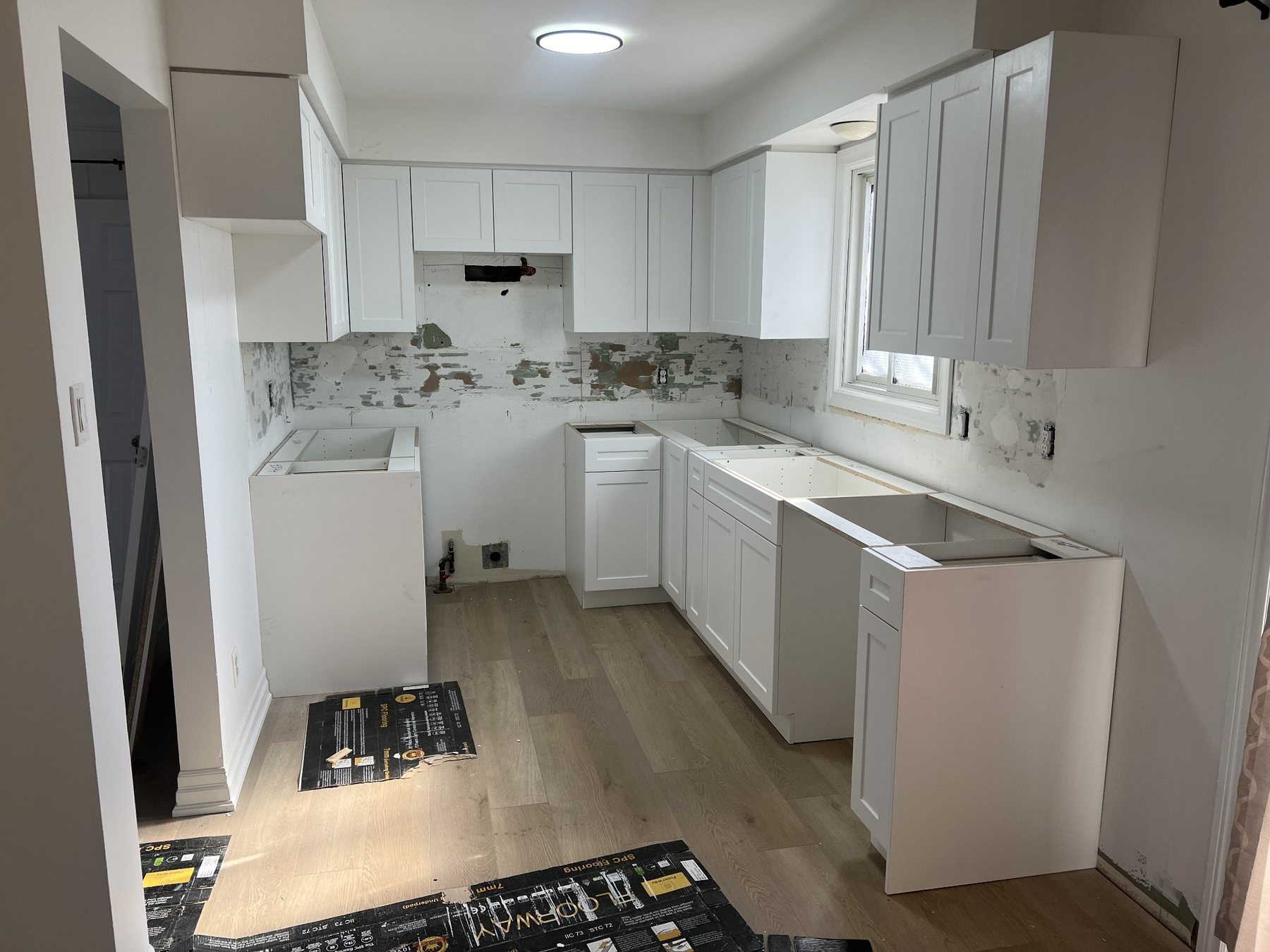 Cabinet detail work during a kitchen refinishing project