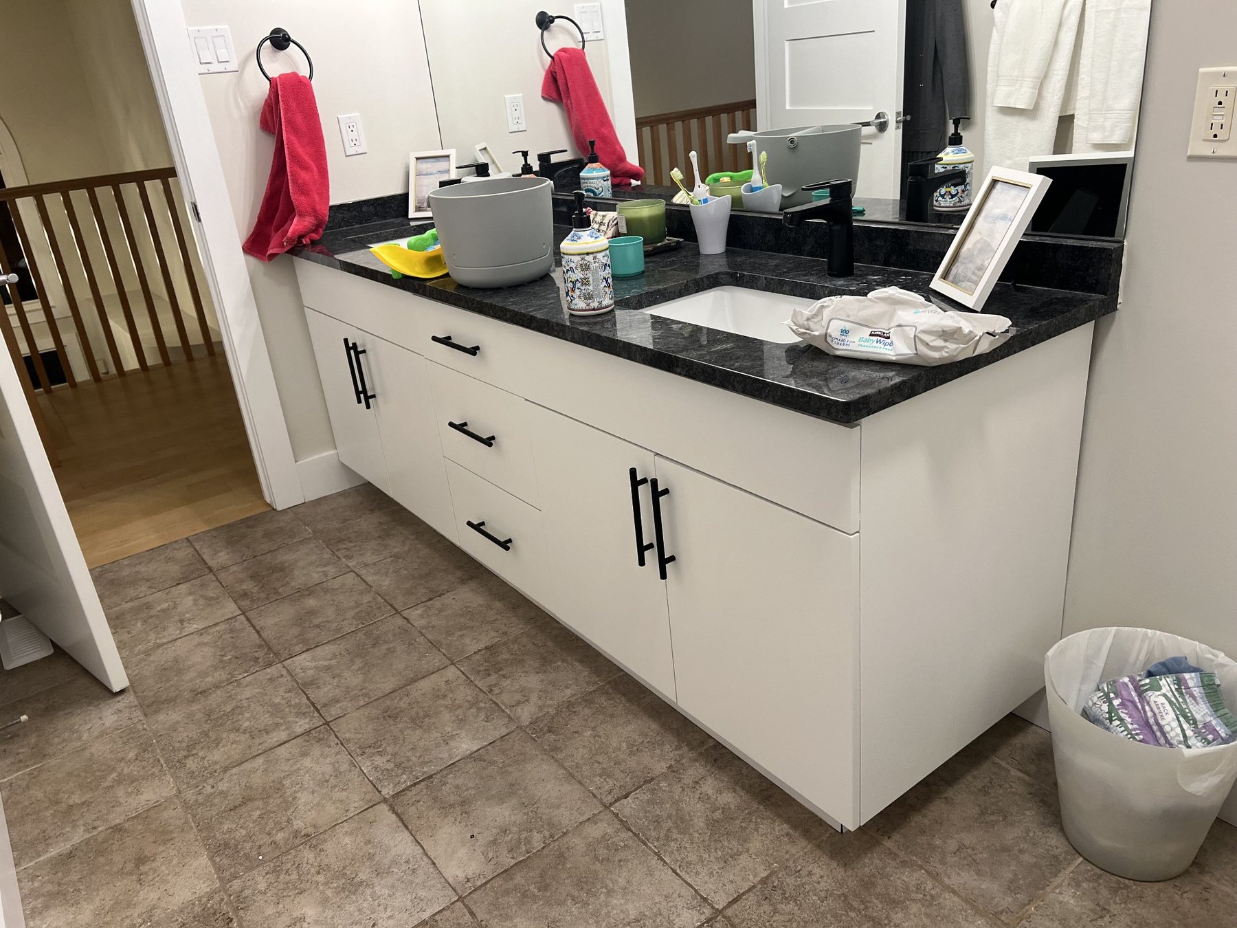 Bathroom vanity cabinet refinishing with white cabinets and black hardware