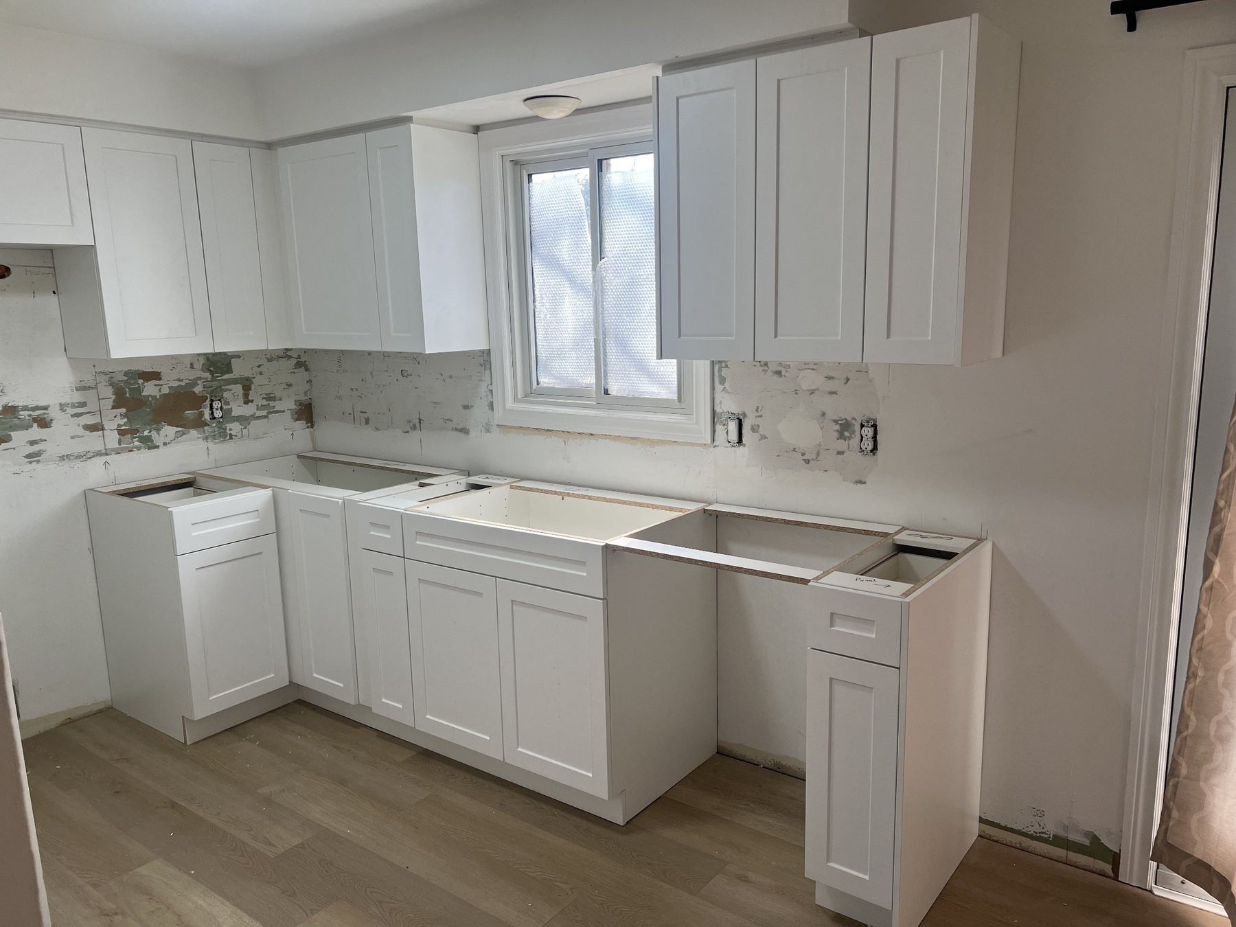 Kitchen cabinet preparation before final finishing and spray refinishing